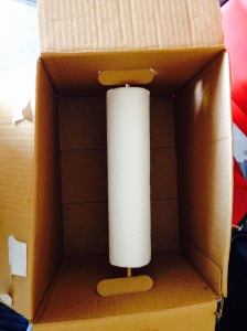Dowel rod through both box holes and the paper towel tube